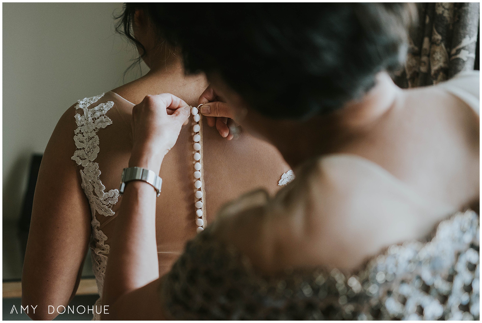 Bride getting into her wedding dress with her mother at the Kimpton Taconic Hotel.