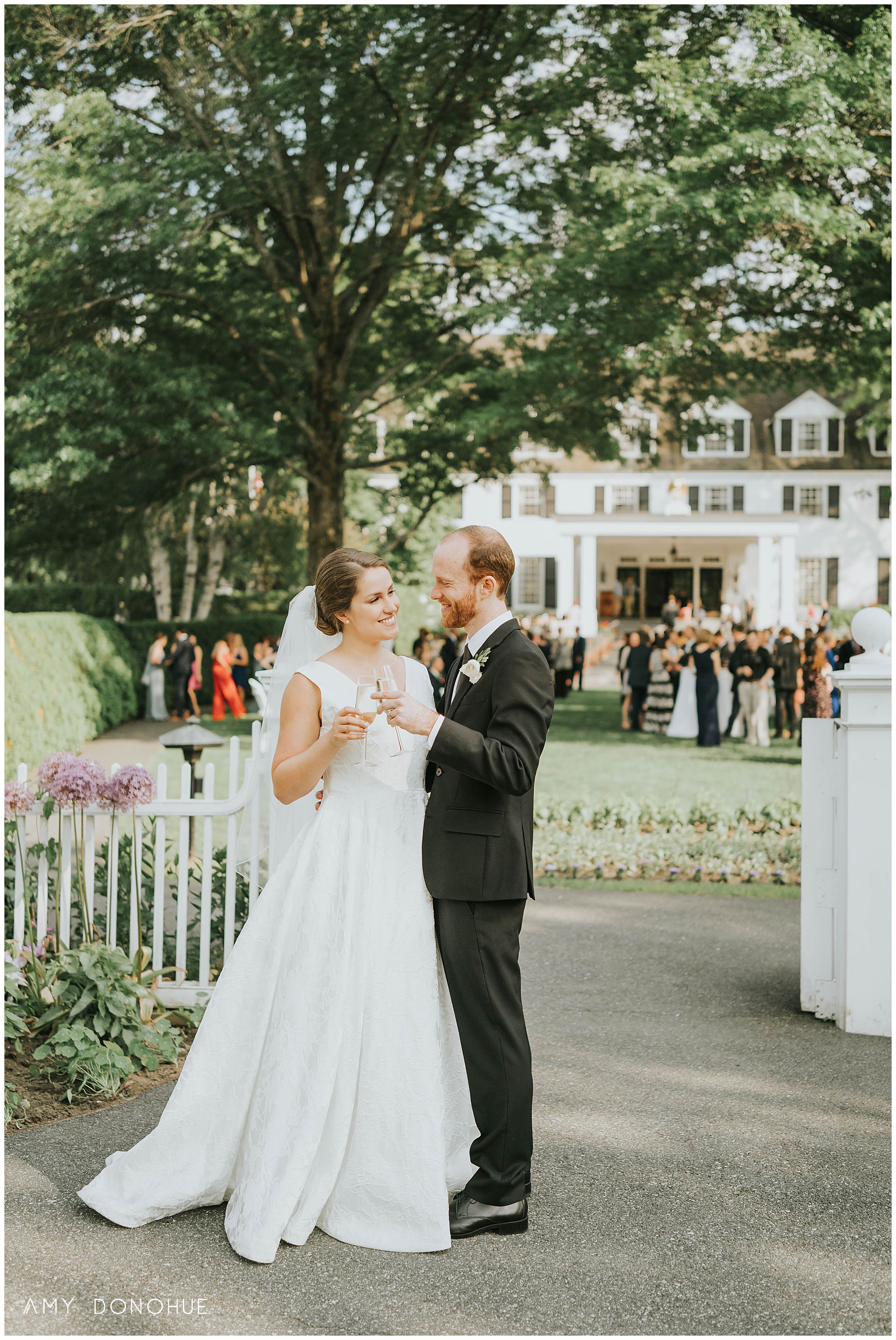 Bride and Groom toasting on the front lawn of The Woodstock Inn & Resort, Woodstock, Vermont
